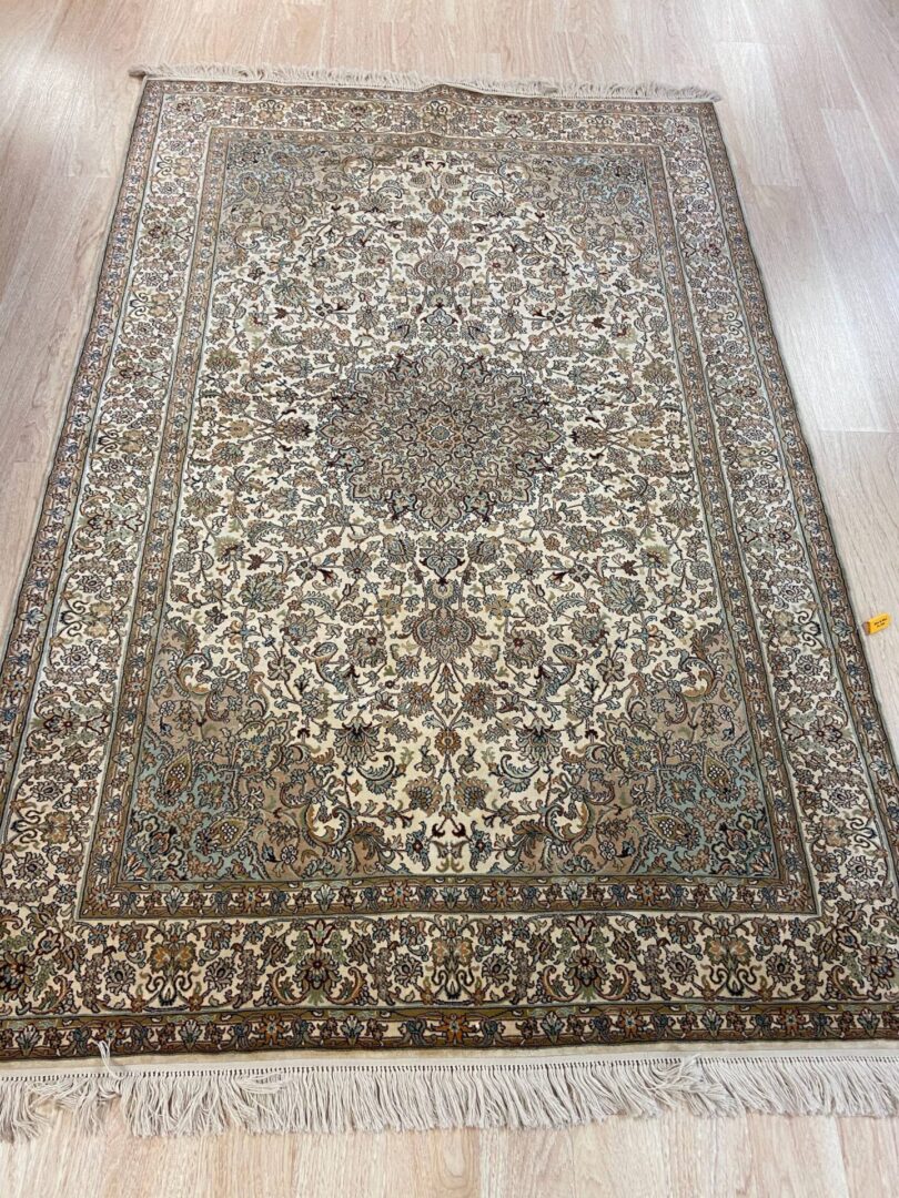 A fine silk carpet with mandala designs