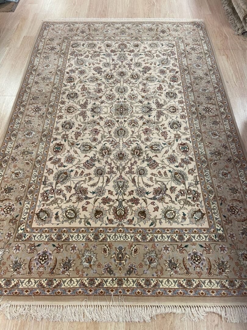 A fine silk carpet with floral designs