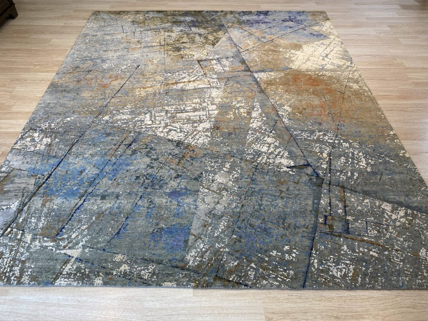 A rug with blue and rust colors